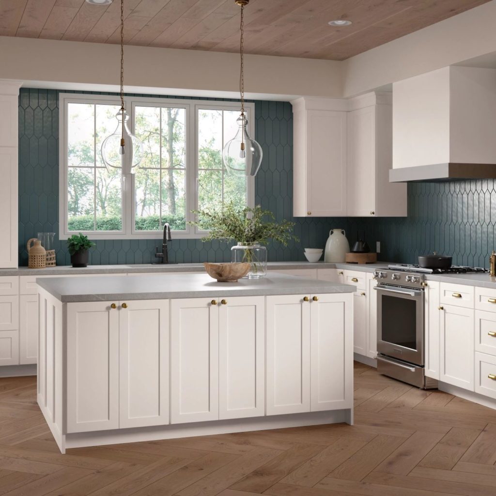 White Shaker Kitchen Cabinets and Work Island in L-Shaped Kitchen - Omni Cabinet Door Style in Snow Finish by Mantra Cabinets