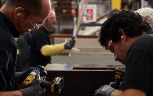 View of one of the assembly line teams creating Mantra Cabinets.